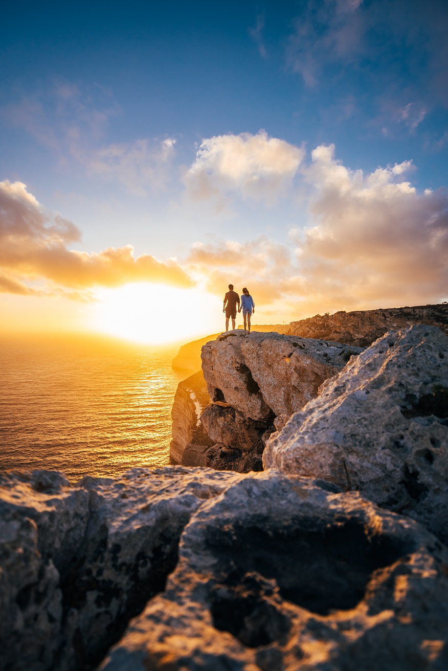 Couple on cliffs of Malta at Sunset